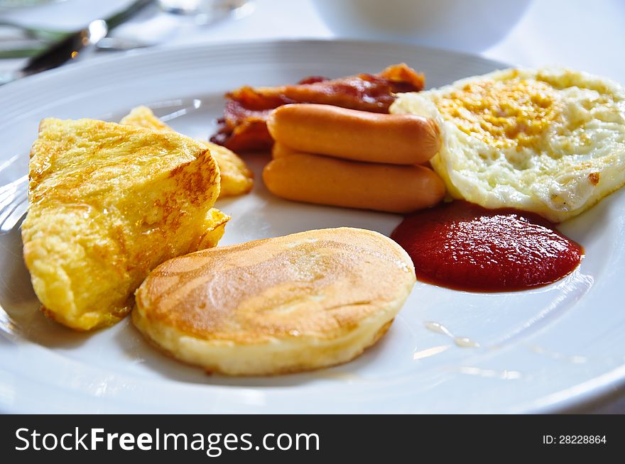 Breakfast - toasts, eggs, bacon and hotdog