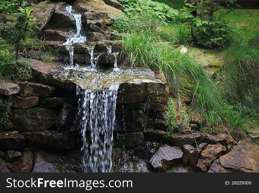 Nice small waterfall in summer forest