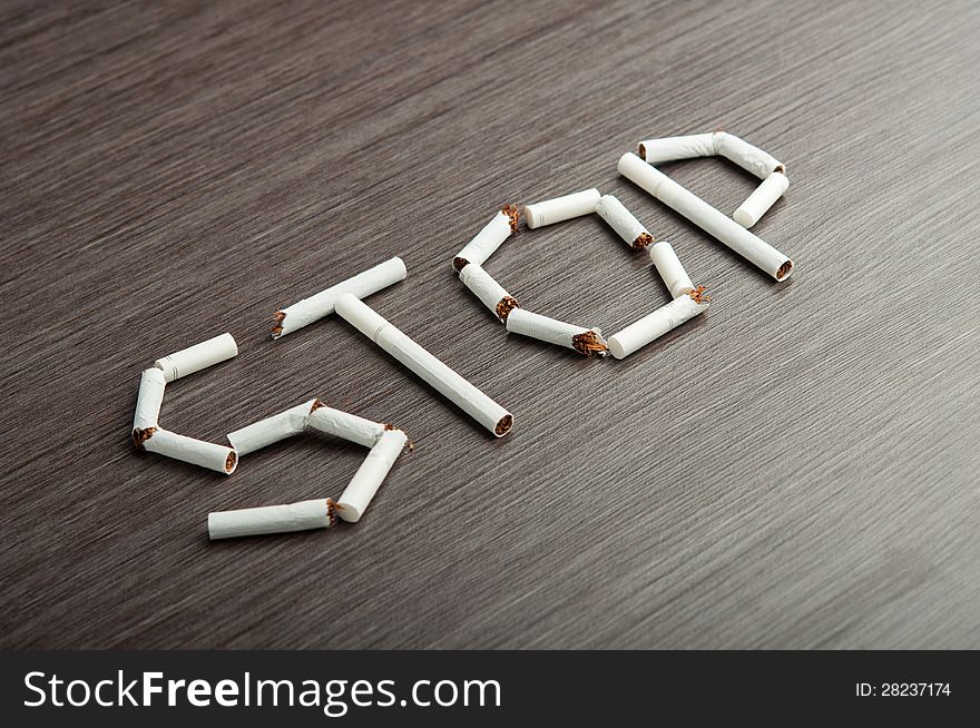 Concept of the dangers of smoking. the word stop of cigarettes. Concept of the dangers of smoking. the word stop of cigarettes
