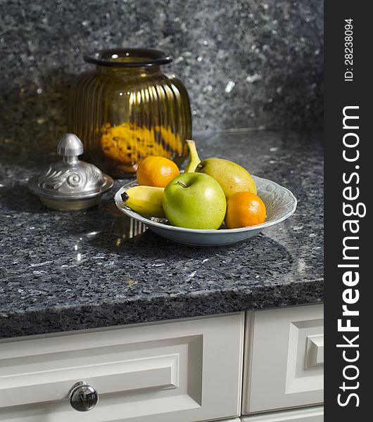 Kitchen counter with bowl of fruit and open cookie jar. Kitchen counter with bowl of fruit and open cookie jar