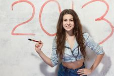 Girl Draws A Christmas Decoration On The Wall. Royalty Free Stock Image