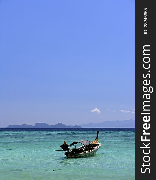 Long tail boat with beautiful sky , clear water at the Lipe Island Thailand