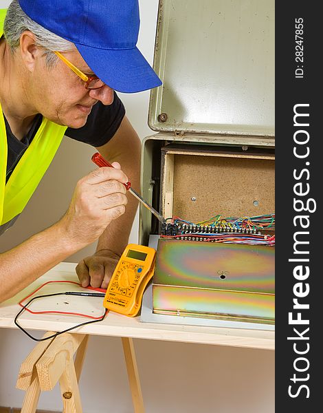 Electrician while working with cables and wires of electronic components. Electrician while working with cables and wires of electronic components