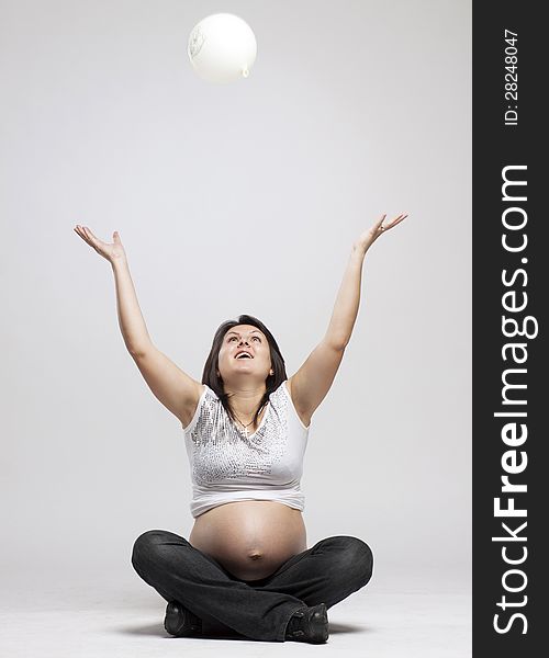 Beautiful pregnant woman playing with balloons