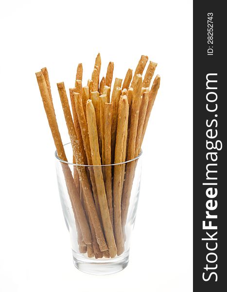 Bread sticks with salt in a glass beaker isolated on a white background