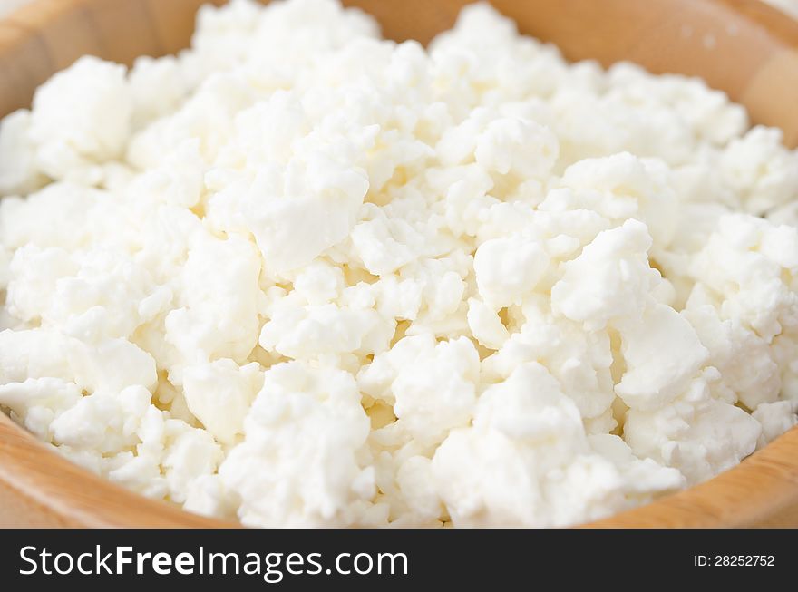 Fresh cottage cheese in a bowl closeup