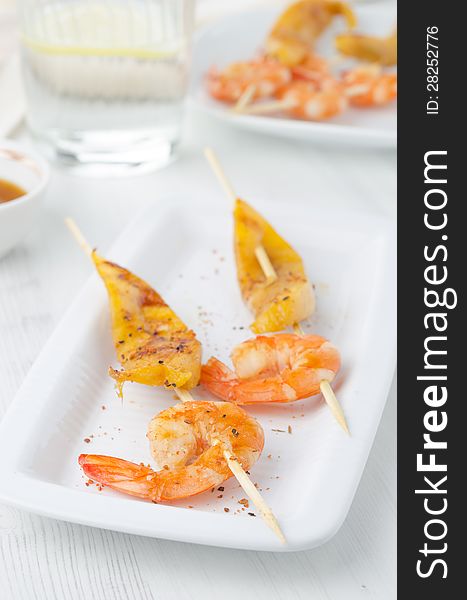 Grilled shrimp and mango in the glaze on white dish