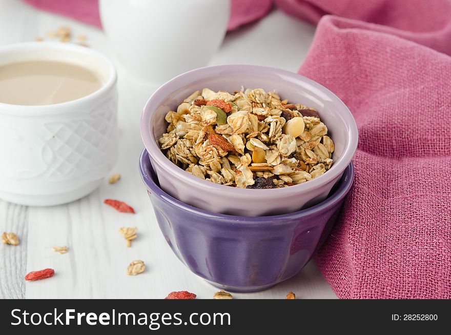 A bowl of homemade granola with goji berries on the table closeup. A bowl of homemade granola with goji berries on the table closeup