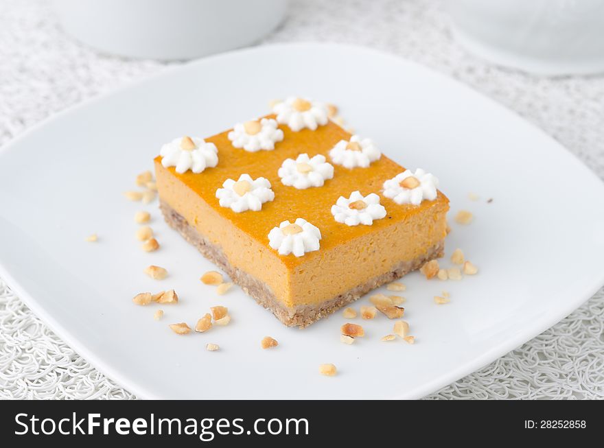 Pumpkin cake, decorated with flowers made of whipped cream and n