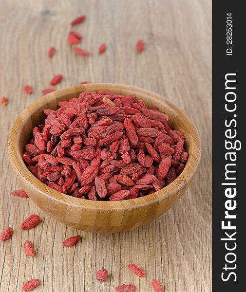 Wooden bowl with goji berries on the table