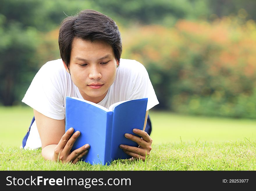 Young man reading a book in outdoor