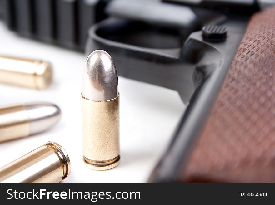 9mm bullets and semi-automatic pistol closeup, shallow dof. 9mm bullets and semi-automatic pistol closeup, shallow dof