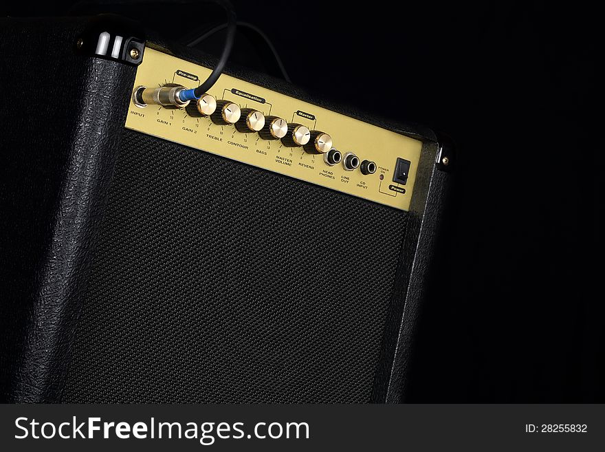 A small guitar amplifier on black background