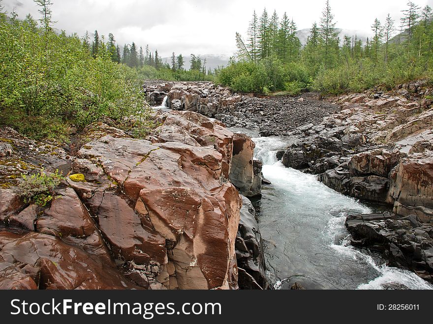 Roaring waterfalls on the river dug canyon