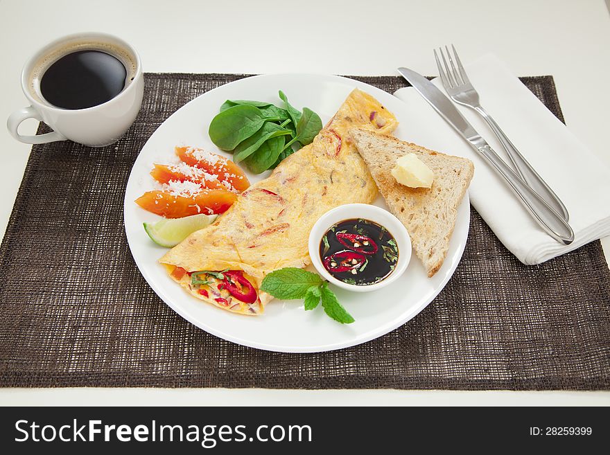 Healthy omelette with chillies, coriander, paw paw, spinach lime and spicy soy sauce. Healthy omelette with chillies, coriander, paw paw, spinach lime and spicy soy sauce