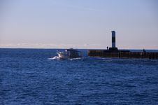 Boat Passing Lighthouse Stock Photo