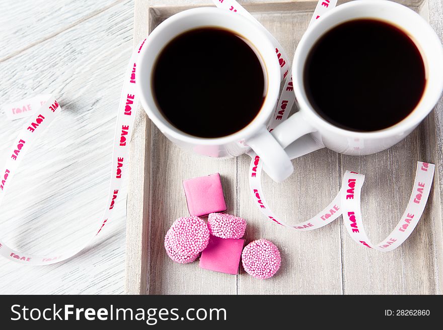 Two Coffee Cups With Pink Candies