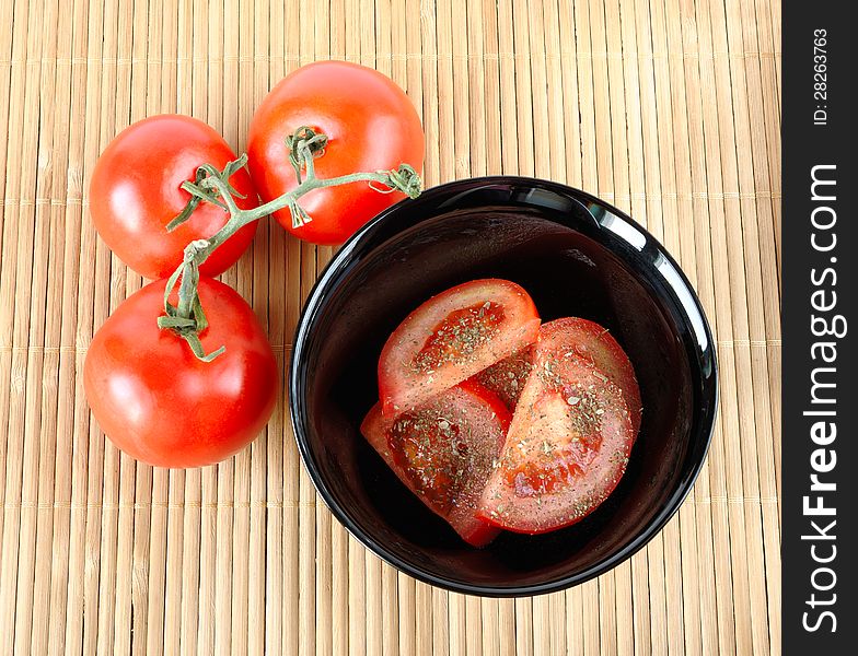 Salad with tomatoes and three tomatoes on a mat