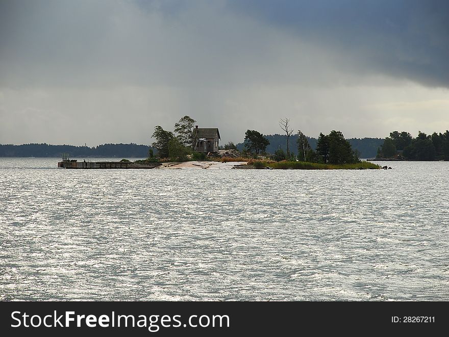 Small island and solitary house, Helsinki harbour, Finland. Small island and solitary house, Helsinki harbour, Finland