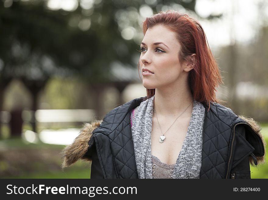 Young woman with green eyes staring off into the distance. Young woman with green eyes staring off into the distance.