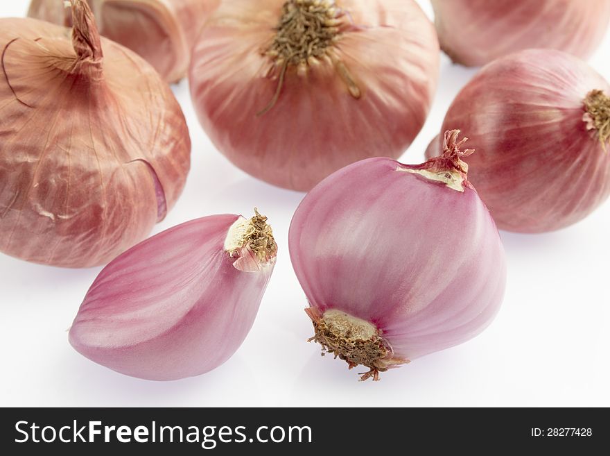 Group of small red shallot on white background