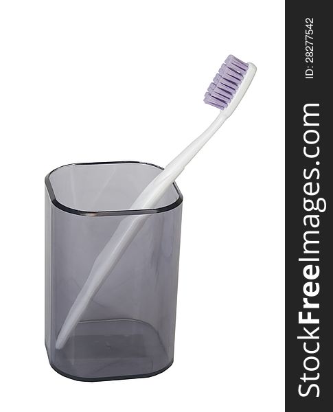 Tooth-brush in a plastic beaker on a white background