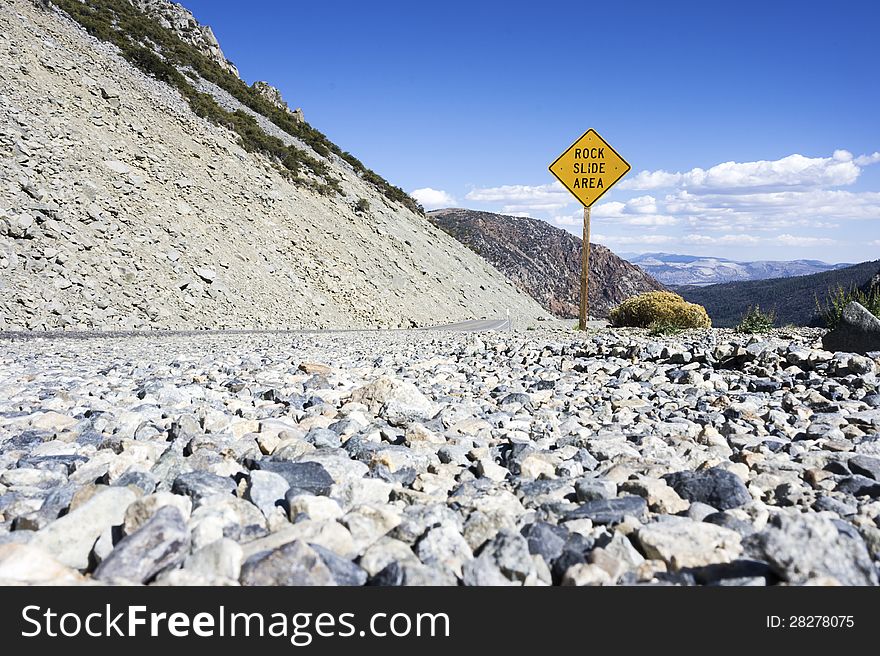 Rock Slide Area Sign Placed in Mountain LAndscape