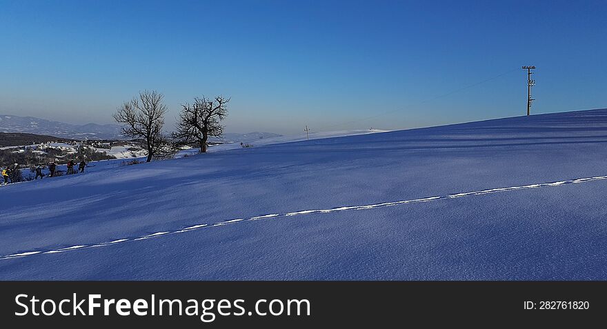 twilight on snowy hills and footprints