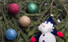 Colorful Balls And Snowman Lying On Spruce Branches. Stock Photos