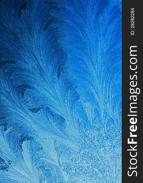 Ice patterns on glass, a blue background. Ice patterns on glass, a blue background.