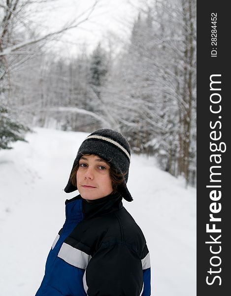 Teen boy outdoors on a snowy winter day. Teen boy outdoors on a snowy winter day