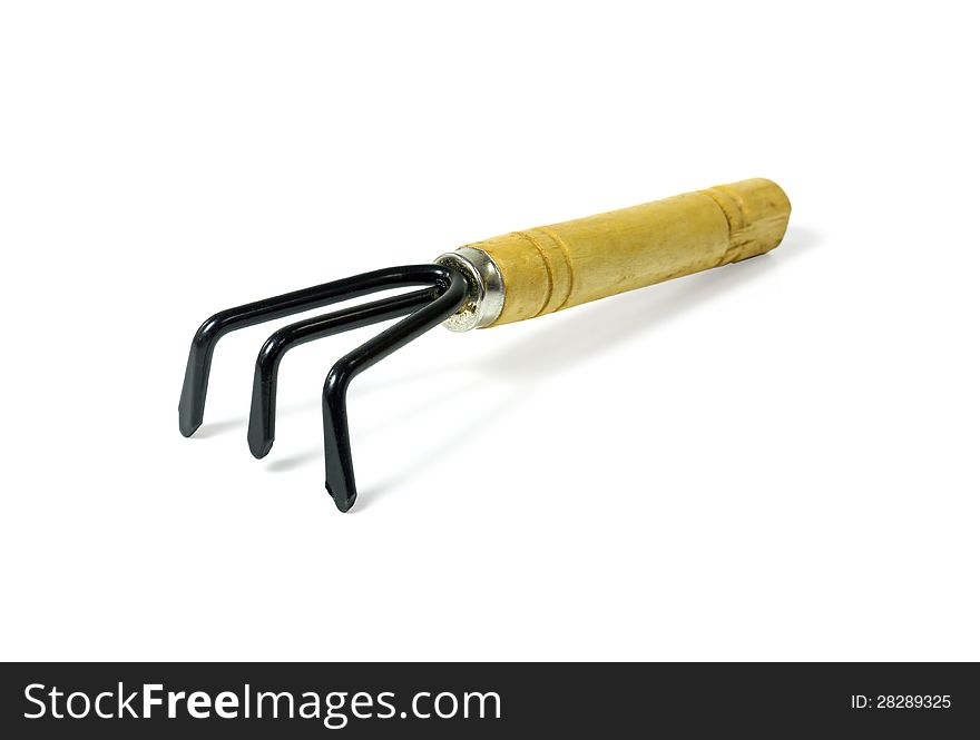 Steel rake with a wooden handle on white background with clipping path