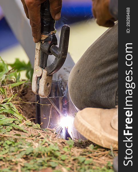 Welder welding elements at the construction site