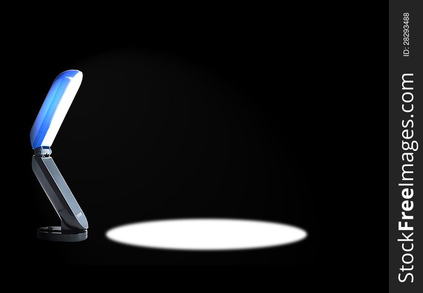 Modern luminous desk lamp with beam of light on black background. Modern luminous desk lamp with beam of light on black background