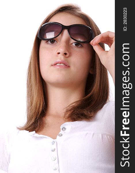 Young teen in sunglasses against white background. Young teen in sunglasses against white background.