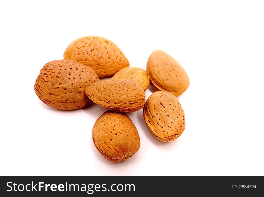Almonds piled up, isolated on white