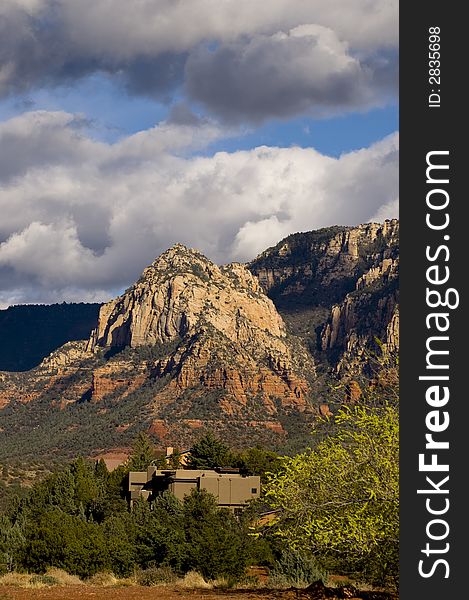 Adobe style house with pine trees near sedona, arizona with red rocks in background. Adobe style house with pine trees near sedona, arizona with red rocks in background