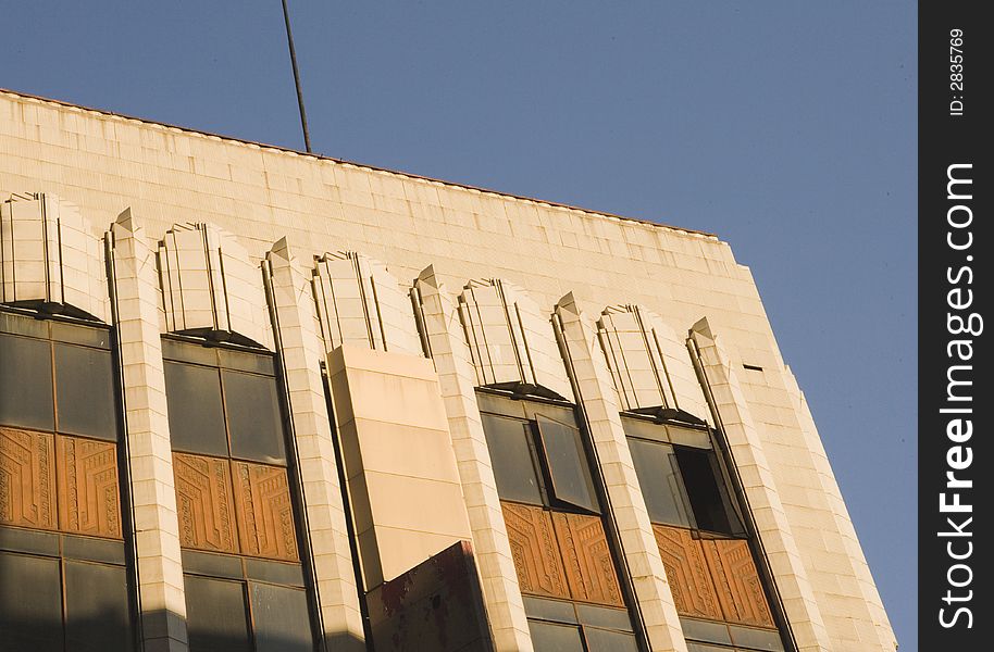 Sunrise against a Art Deco buiulding's facade. Sunrise against a Art Deco buiulding's facade.