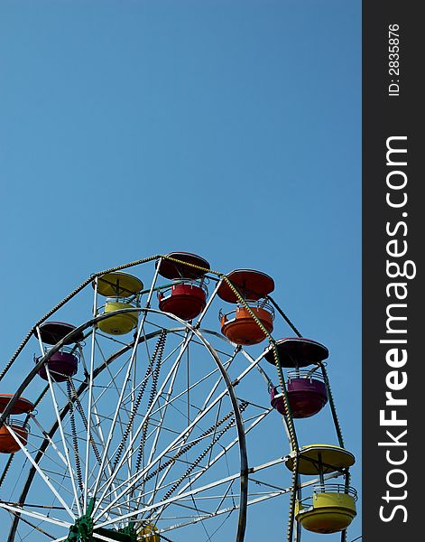 Ferris wheel with multicolored gondolas.