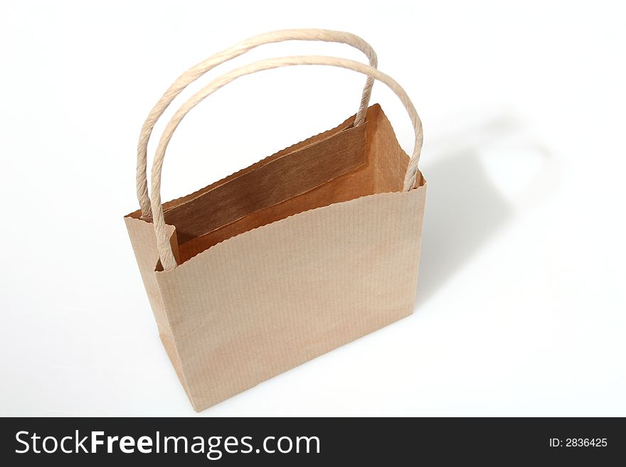 Empty brown paperbag isolated on white, perfect to put your design on the side. Empty brown paperbag isolated on white, perfect to put your design on the side