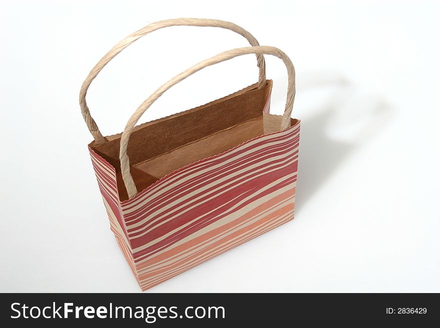 Empty red striped paperbag isolated on white. Empty red striped paperbag isolated on white