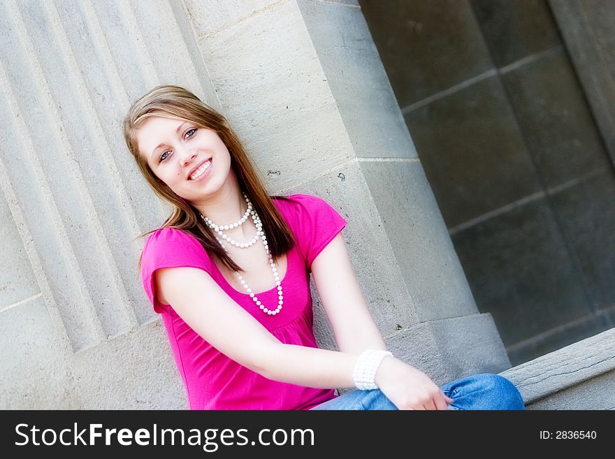 Portrait of a smiling teen sitting on the school steps. Portrait of a smiling teen sitting on the school steps.