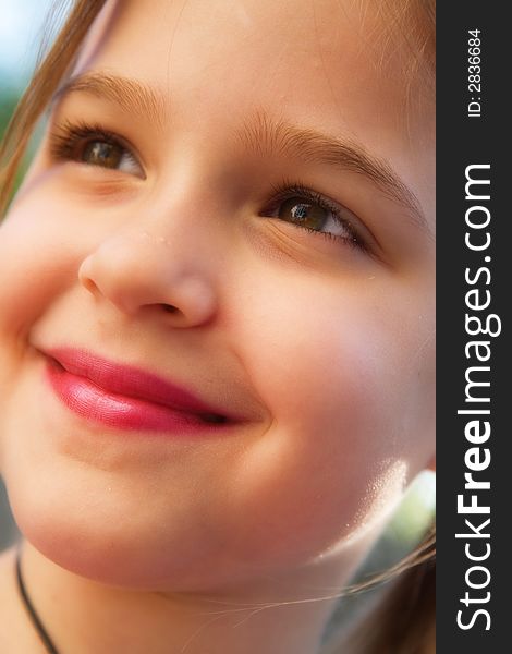 Full face portrait of a pretty little girl in natural light. Full face portrait of a pretty little girl in natural light.