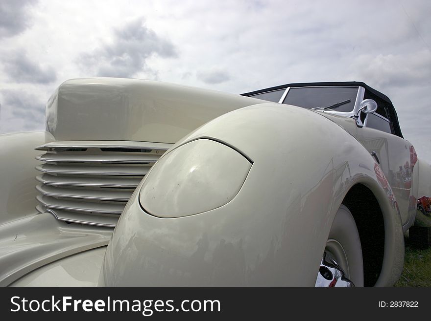 White old car on a background cloud sky