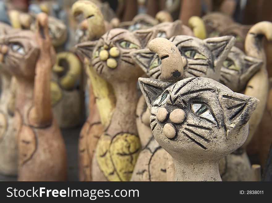 Ceramic decorative cats standing in the row