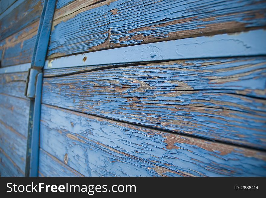 Grunge wooden background made of damaged planks with damaged color surface.