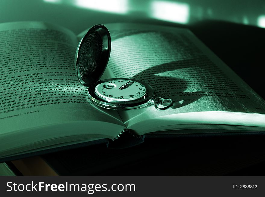 Photo old pocket watch on the book with afternoon shadows. Photo old pocket watch on the book with afternoon shadows