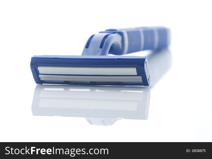 Blue plastic razor with reflection isolated on white. Shallow depth of field with the handle out of focus. Blue plastic razor with reflection isolated on white. Shallow depth of field with the handle out of focus.