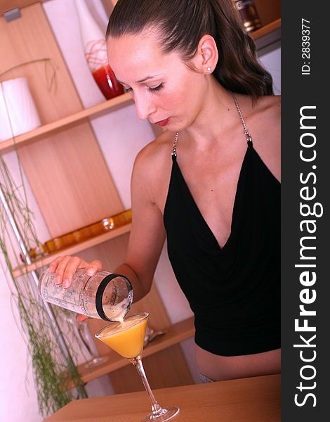 woman pours cocktail into the glass. woman pours cocktail into the glass