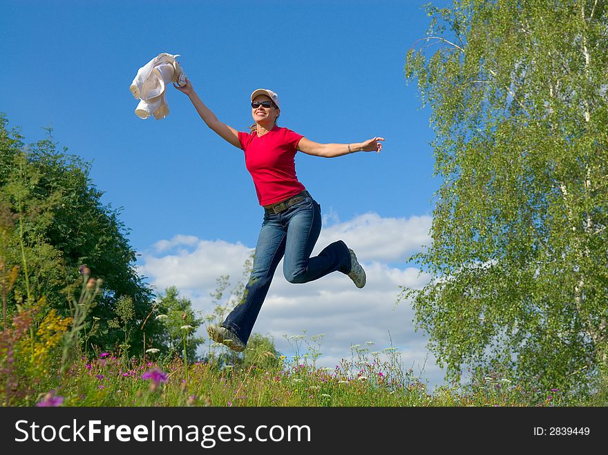 Beautiful lady jumping in summer landscape. Beautiful lady jumping in summer landscape